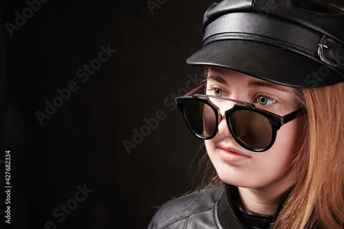 portrait of girl in sunglasses and leather cap