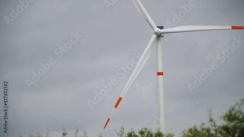 Storm clouds over a wind turbine in a wind energy farm in Mexico, medium shot