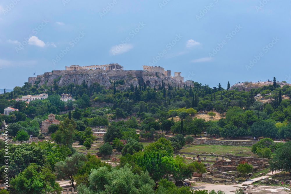 View of the Acropolis of Athens and ancient greek ruins, famous tourist attraction in Greece, in sunny summer day