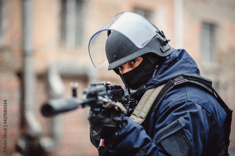 Police. Police officer with weapon and helmet posing on camera. Special Forces Police. Police officer with weapon and helmet posing on camera. Special Forces