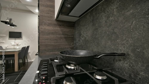 Gas stove top at modern dark brown, gray and black ktchen photo