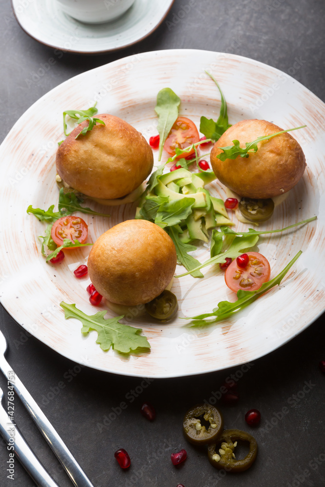 Middle eaterns fried donuts served with avocado Middle eaterns fried donuts served with avocado