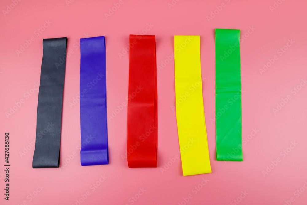 Set of elastic rubber bands for fitness on a pink background. Top view Set of elastic rubber bands for fitness on a pink background. Top view
