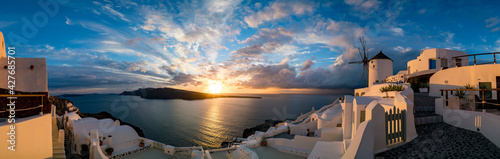 Windmill in Oia village on Santorini island during sunset