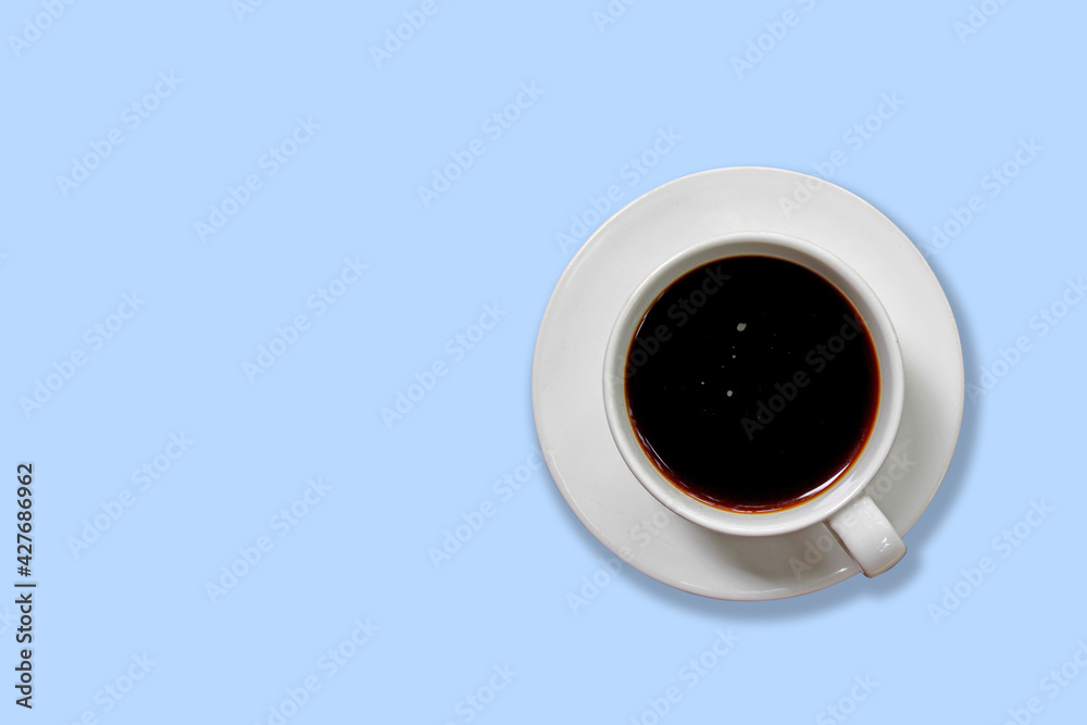 Hot coffee, Americano in a white cup isolated on blue pastel color. Hot coffee, Americano in a white cup isolated on blue pastel color.