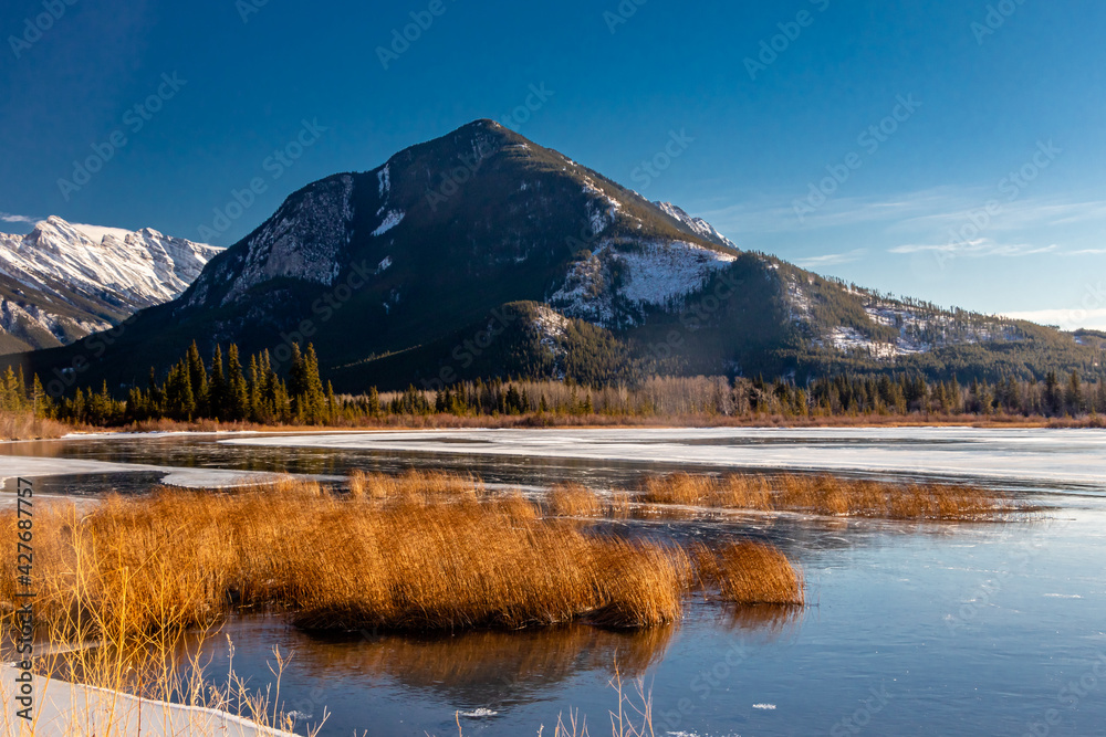 Sulphur Mountain and a partially frozen Vermillion Lakes. Banff National Park, Alberta, Canada