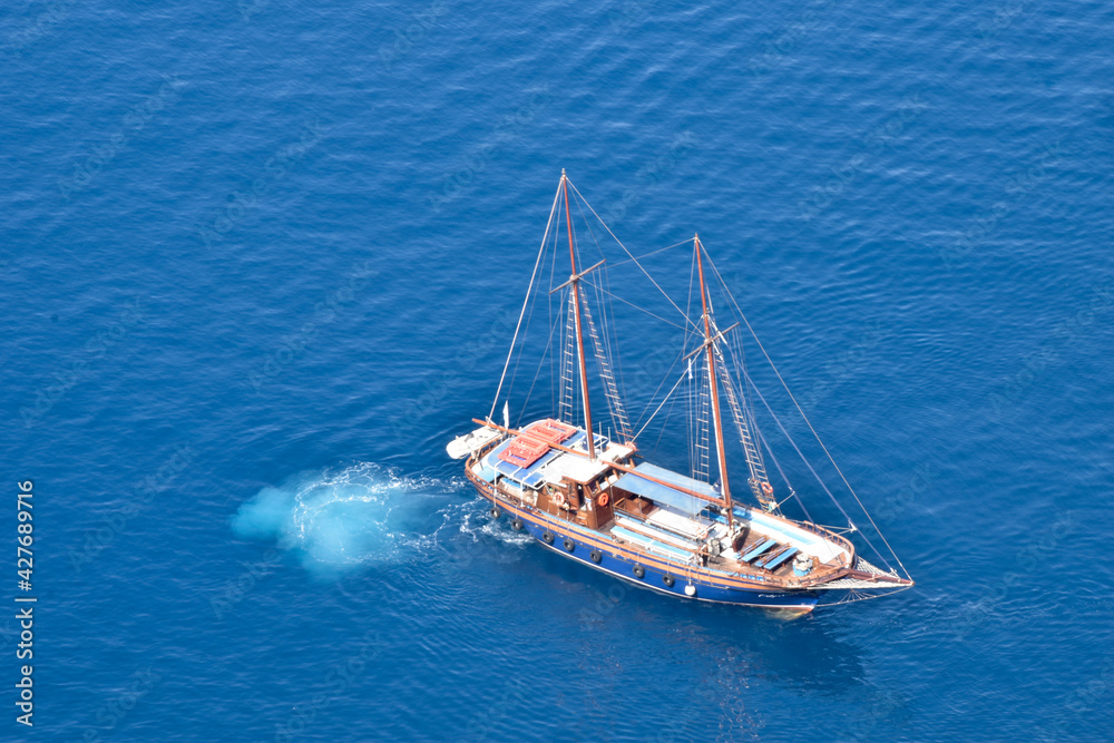 sailboat from above in turquoise blue water