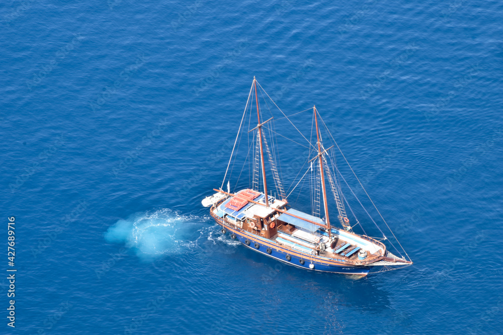 sailboat from above in turquoise blue water sailboat from above in turquoise blue water