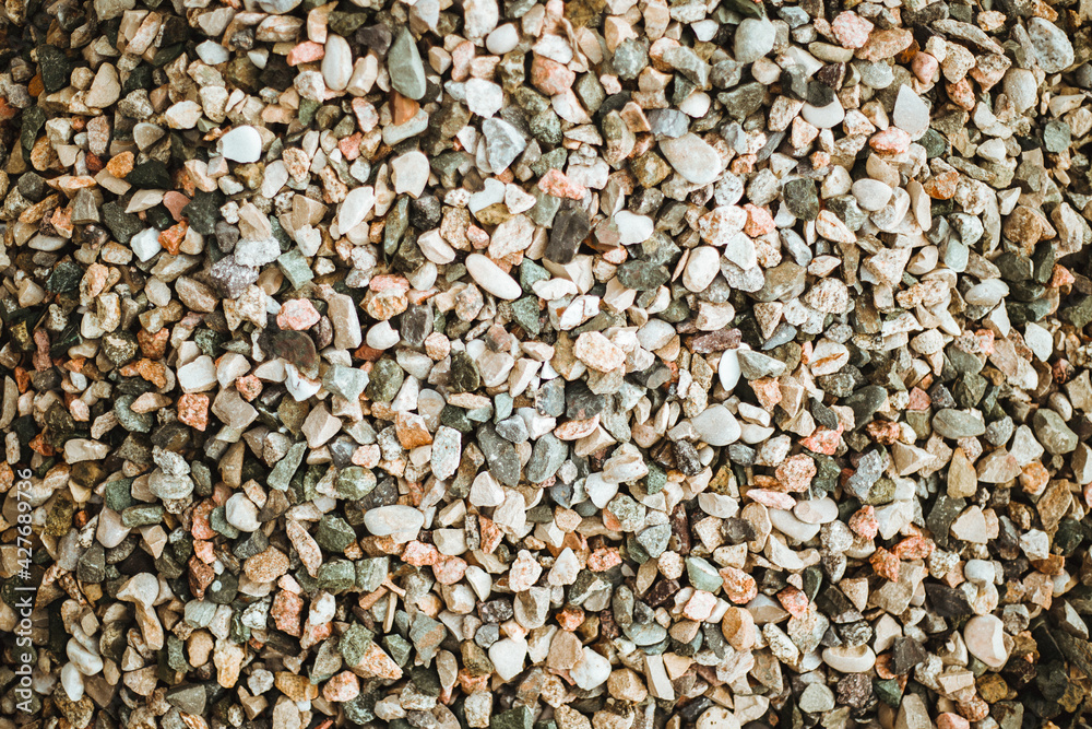 The background is made of stones of different sizes and colors. The texture of natural stones. The background is made of stones of different sizes and colors. The texture of natural stones.