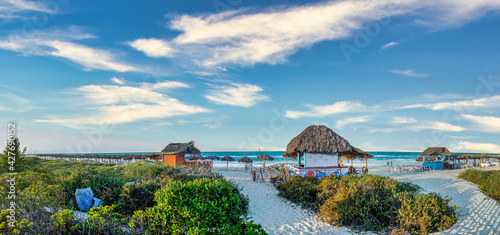 Photography Panoramic view of tropical beach resort by the sea with huts, bars and shading a