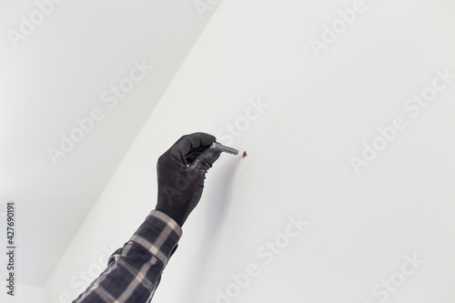Tableau sur toile The carpenter sets the dowel into the wall.
