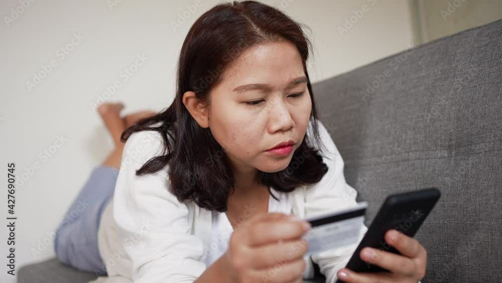 slow motion scene on adult asian woman use smartphone and clicking on shopping online website to select and make payment by credit card for convenience and daily lifestyle concept slow motion scene on adult asian woman use smartphone and clicking on shopping online website to select and make payment by credit card for convenience and daily lifestyle concept