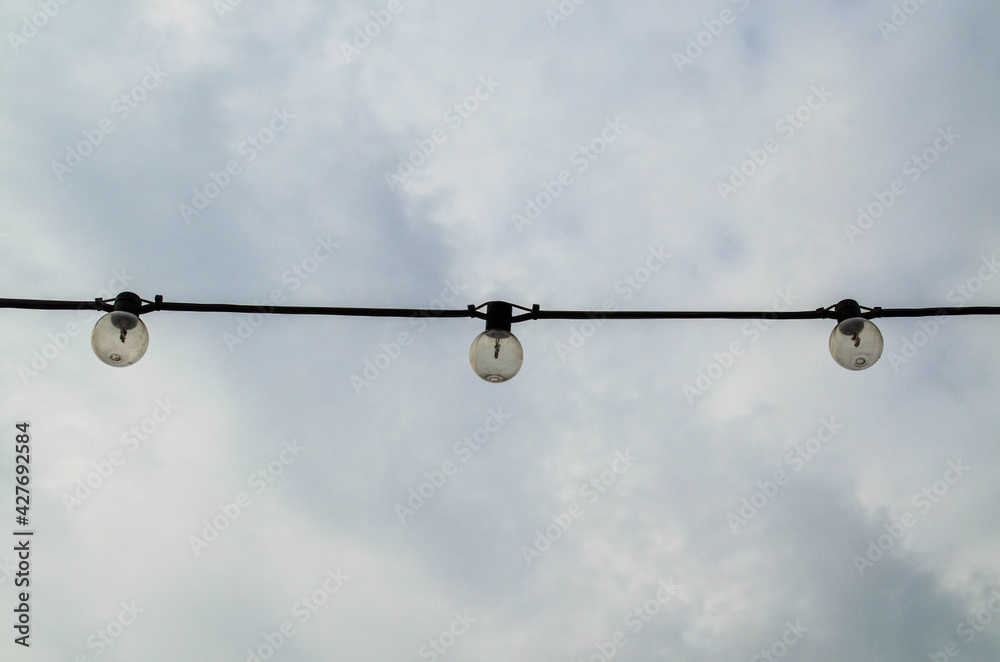 lamps on a wire, against the background of the sky lamps on a wire, against the background of the sky