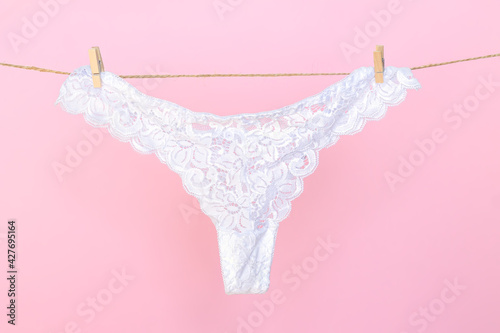 Female white sexy lace panties hanging on clothesline