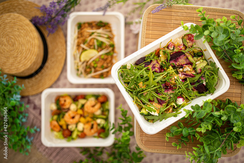 salad with rucola beetroot and feta cheese. vegetarian food. shrimp salad and Asian pad thai.composition with natural decor. concept food delivery