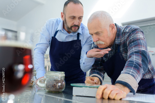 quality control workers smelling ingredient held in hand