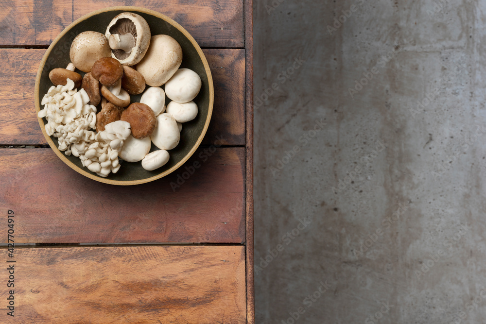 Several mushrooms in a plate on a rustic wooden table Several mushrooms in a plate on a rustic wooden table
