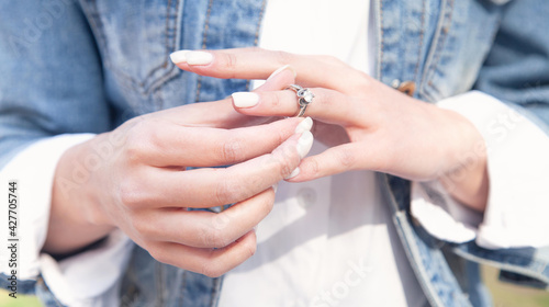 Young woman showing her engagement ring.
