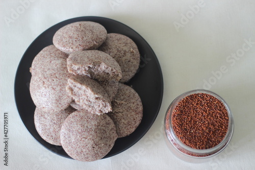 Steamed cakes made with finger millets and skinned black gram. Locally known as Ragi idli. photo