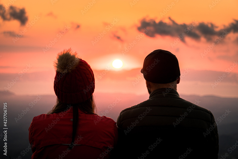 Silhouette of couple watching beautiful sunset