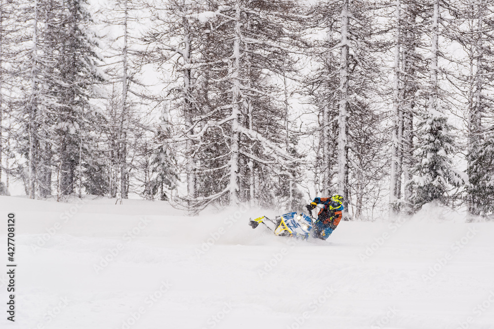 Mountain snowmobile riders ride on the slopes Mountain snowmobile riders ride on the slopes