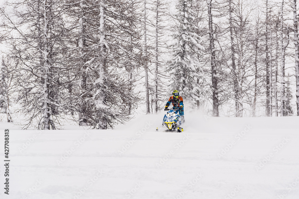 Mountain snowmobile riders ride on the slopes Mountain snowmobile riders ride on the slopes