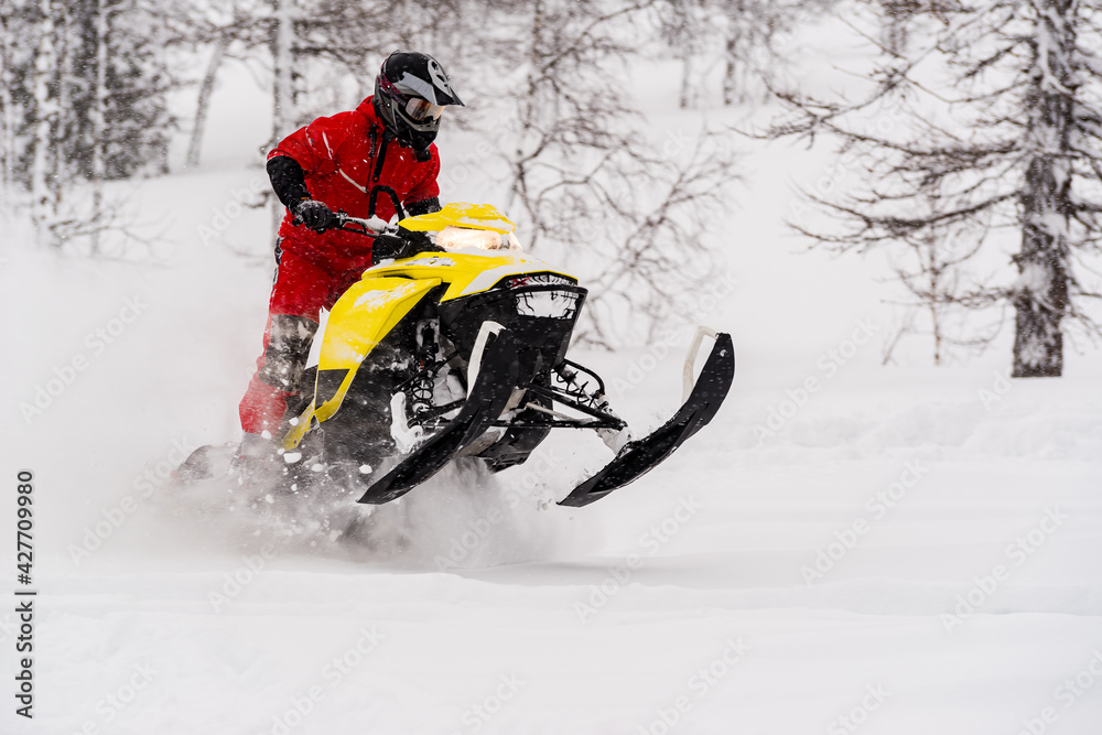 Mountain snowmobile riders ride on the slopes Mountain snowmobile riders ride on the slopes