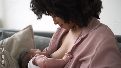 Mother feed child with breast milk Spbd. Biracial african woman hold little cute newborn child