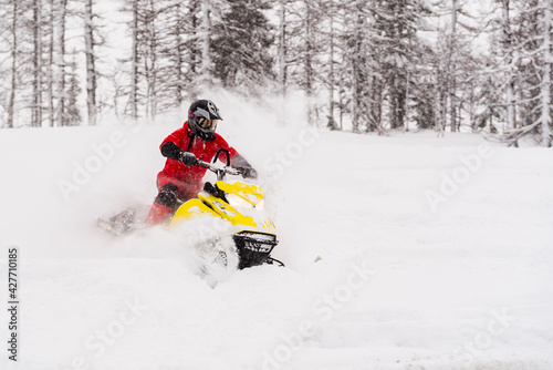 Mountain snowmobile riders ride on the slopes © littleboy72