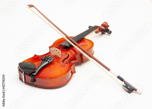 A violin with a bow on a white background. Classical musical instruments