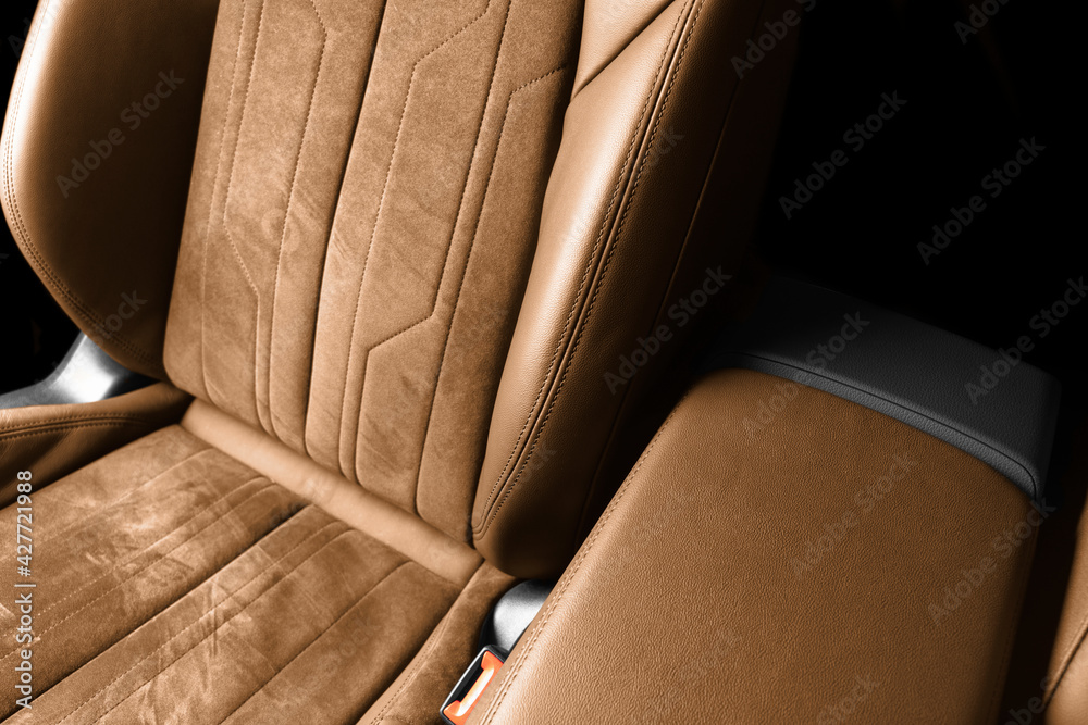 Modern luxury car brown leather with alcantara interior. Part of orange  leather car seat details with white stitching. Interior of prestige car.  Perforated leather seats isolated. Perforated leather. Stock Photo | Adobe