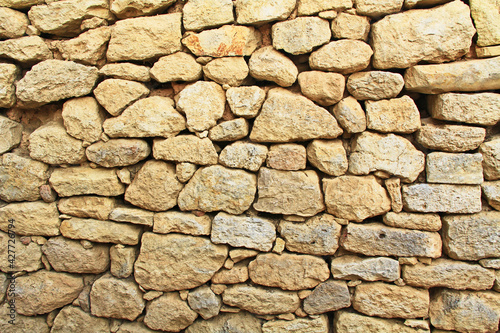 Stone background texture of a wall from The Palace of Knossos on Crete in Greece near Heraklion is called Europe’s oldest city and the ceremonial and political center of the Minoan civilization. 