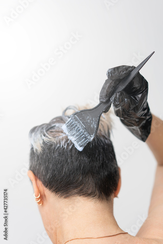 A woman dyes her hair on her own