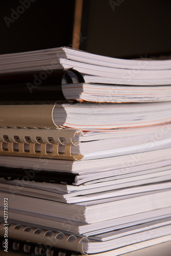 Stack of reports lies on a desk ready for review