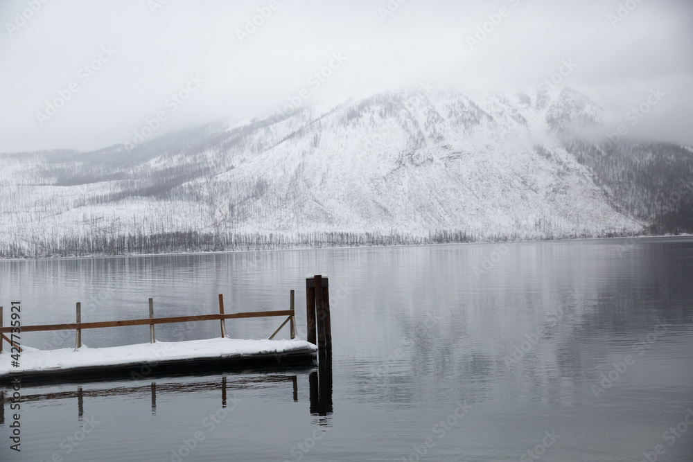 tranquil winter lake reflection with a dock