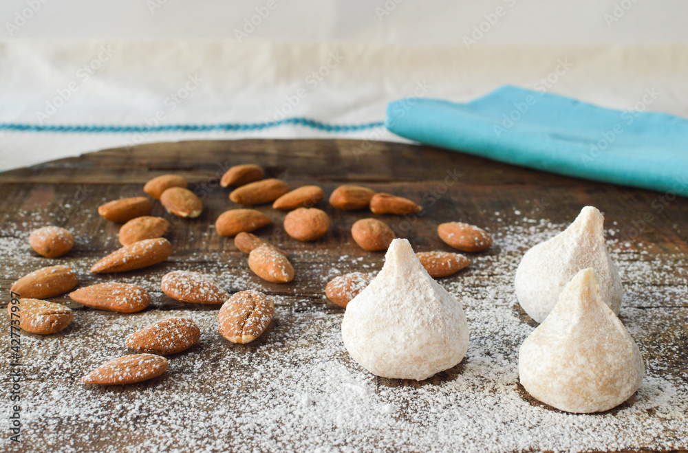 Traditional Greek almond cookies amygdalota, with powdered sugar and almonds 