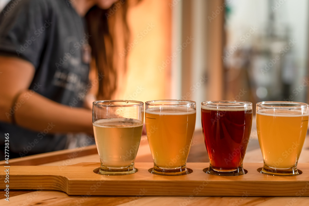 Ordering a flight of craft beer from a local brewery Ordering a flight of craft beer from a local brewery