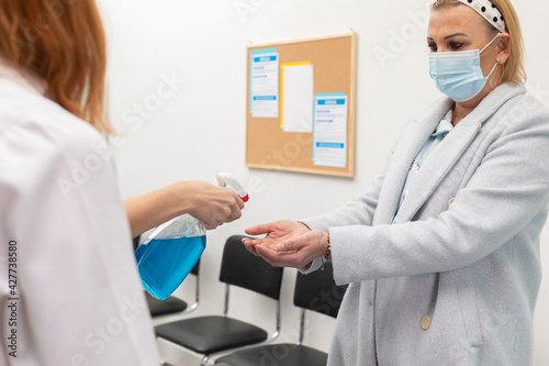Hand disinfection of patients entering clinics by medical staff in the face of an ongoing pandemic