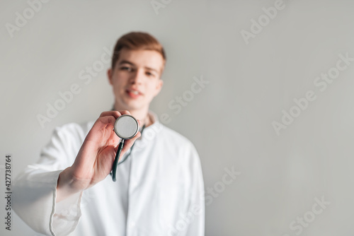Studio shot of young doctor guy student in the clinic in practice