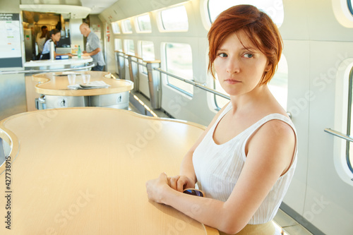 woman riding by train at the dining-car table. traveler on the road.