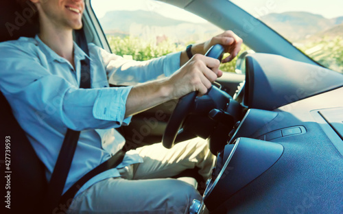 man driving a car. people traveling at the wheel.