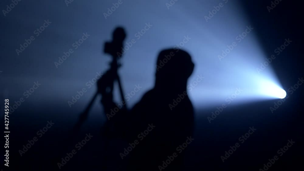 silhouette of the photographer in the backlight of the projector
silhouette of the photographer in the backlight of the projector