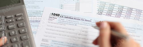 There is an individual tax deduction document and calculator on table