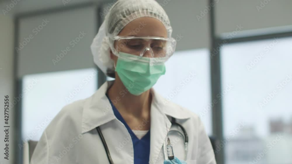 The procedure nurse prepares for the introduction of the vaccine, releases air from the syringe and wipes the patients hand with an antiseptic, slowmotion. The procedure nurse prepares for the introduction of the vaccine, releases air from the syringe and wipes the patients hand with an antiseptic, slowmotion.