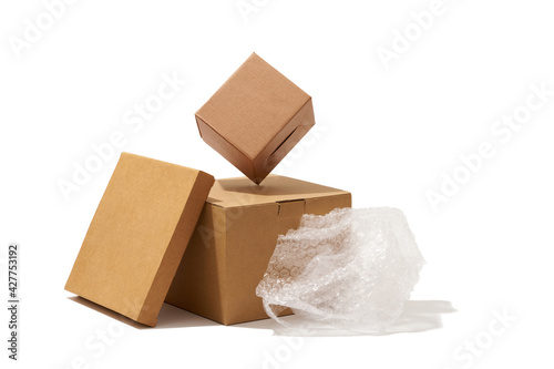 Different shaped cardboard boxes and bubble wrap isolated on white background