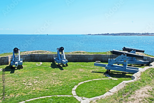 Vintage canon are mounted at Fort Phoenix guarding the entrance to the harbor in Fairhaven, Massachusetts. photo