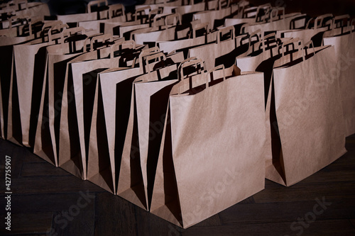 Craft paper bags. The concept of delivering goods or food from stores. Space for a logo or design. Environmentally friendly bags.