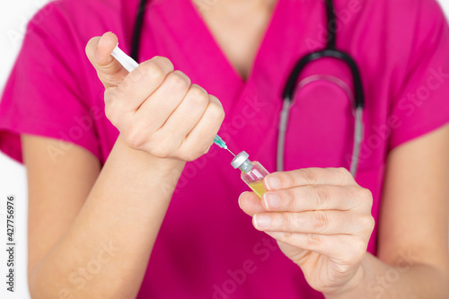 Female nurse in medical uniform. Injection vaccine drug in female doctor hands. medicine and vaccine concept. 