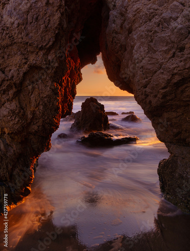 Sunset through a sea cave in Malibu.   photo