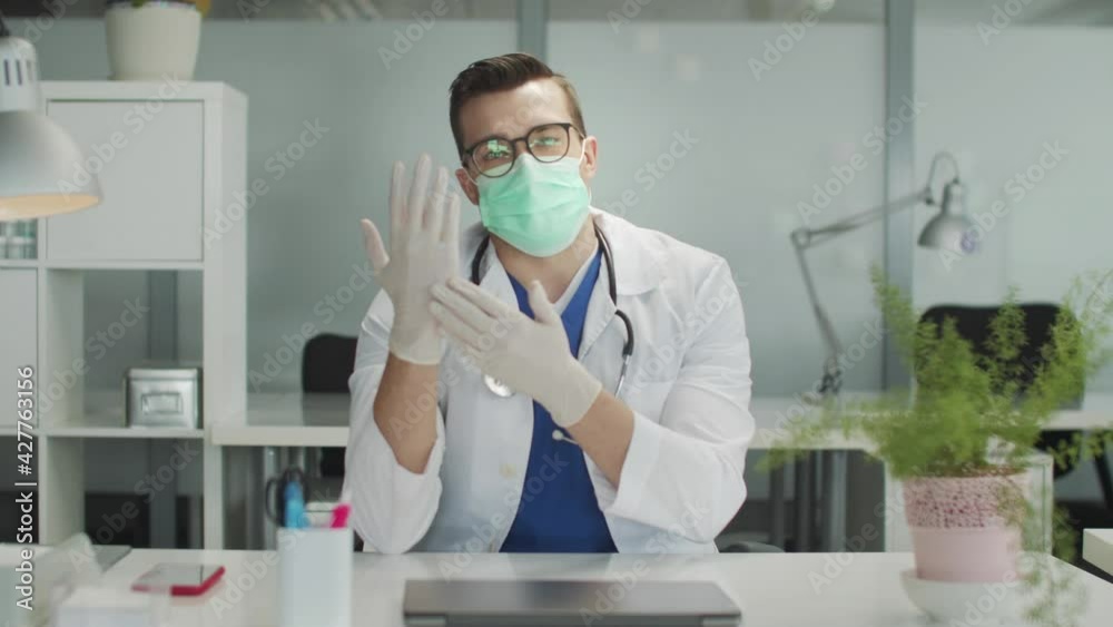 The doctor tells the camera about the basic rules of protection against viral infections and covid-19. Medical gloves, masks, and hand disinfection as ways to combat the spread. The doctor tells the camera about the basic rules of protection against viral infections and covid-19. Medical gloves, masks, and hand disinfection as ways to combat the spread.